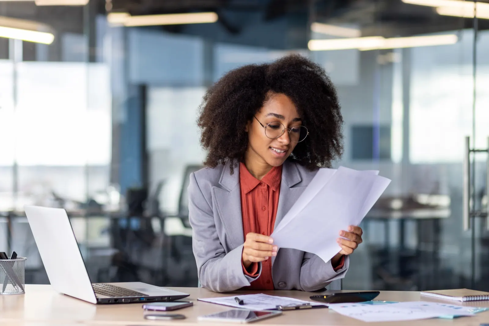 Accountant reviewing financial documents at her desk